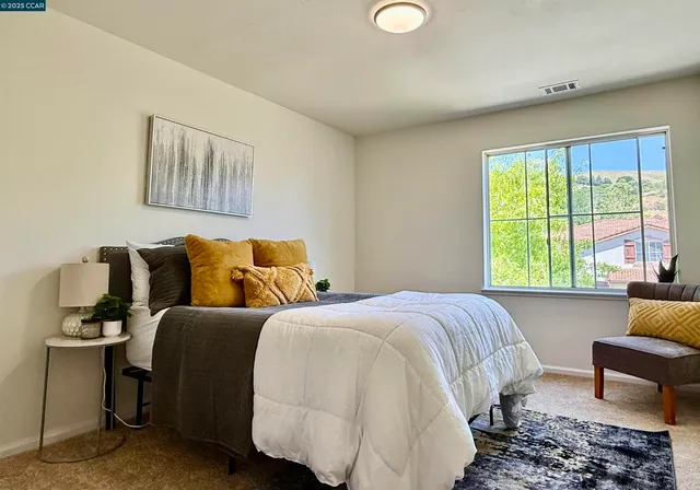 a bedroom with a bed and a couch