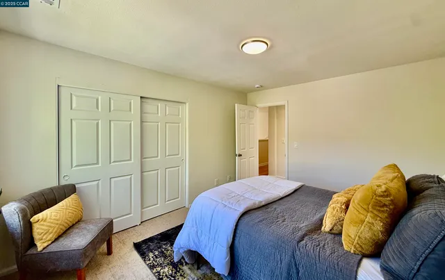 a bed sitting in a bedroom next to a window