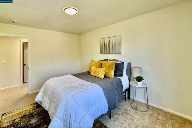 a bedroom with a bed lamp and window