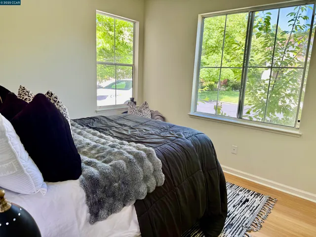 a bed sitting in a bedroom next to a window