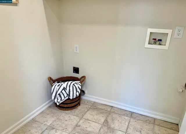 a view of a lake with a table and chairs in the patio