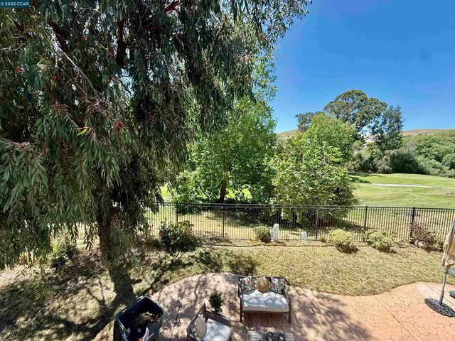 a view of a backyard with sitting area