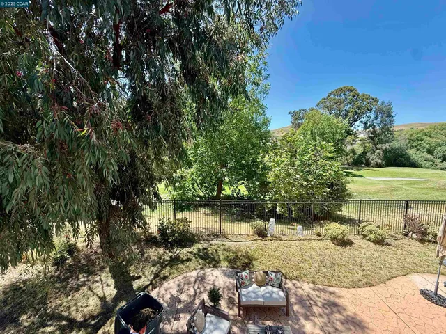 a view of a backyard with sitting area