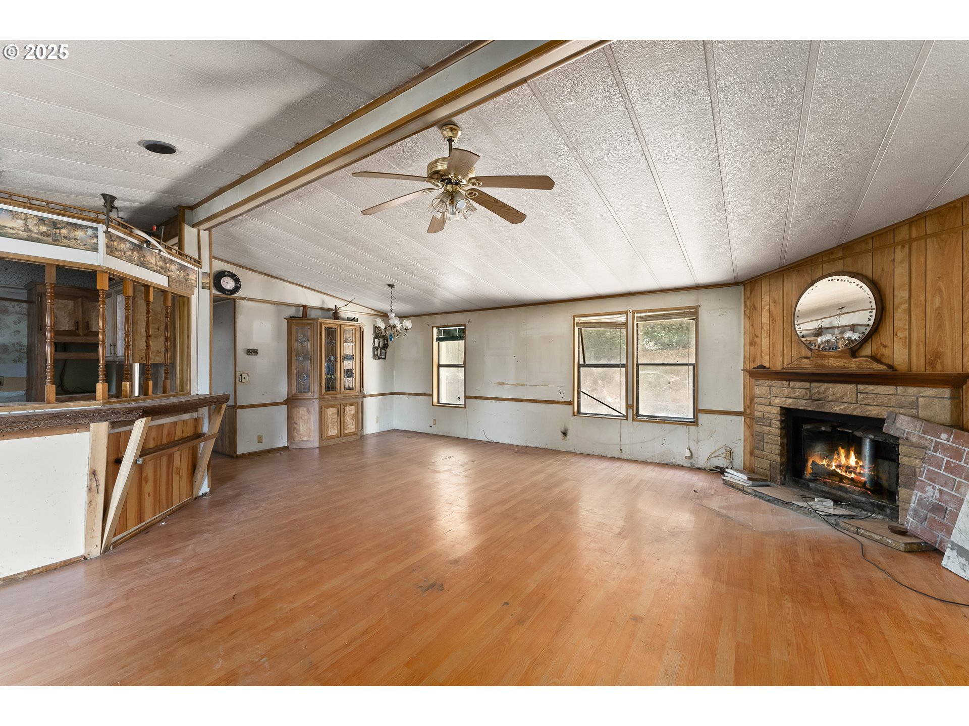 281 Callahan Road Roseburg, OR 97471 - Photo 13 of 39 a view of an empty room with a fireplace and a window