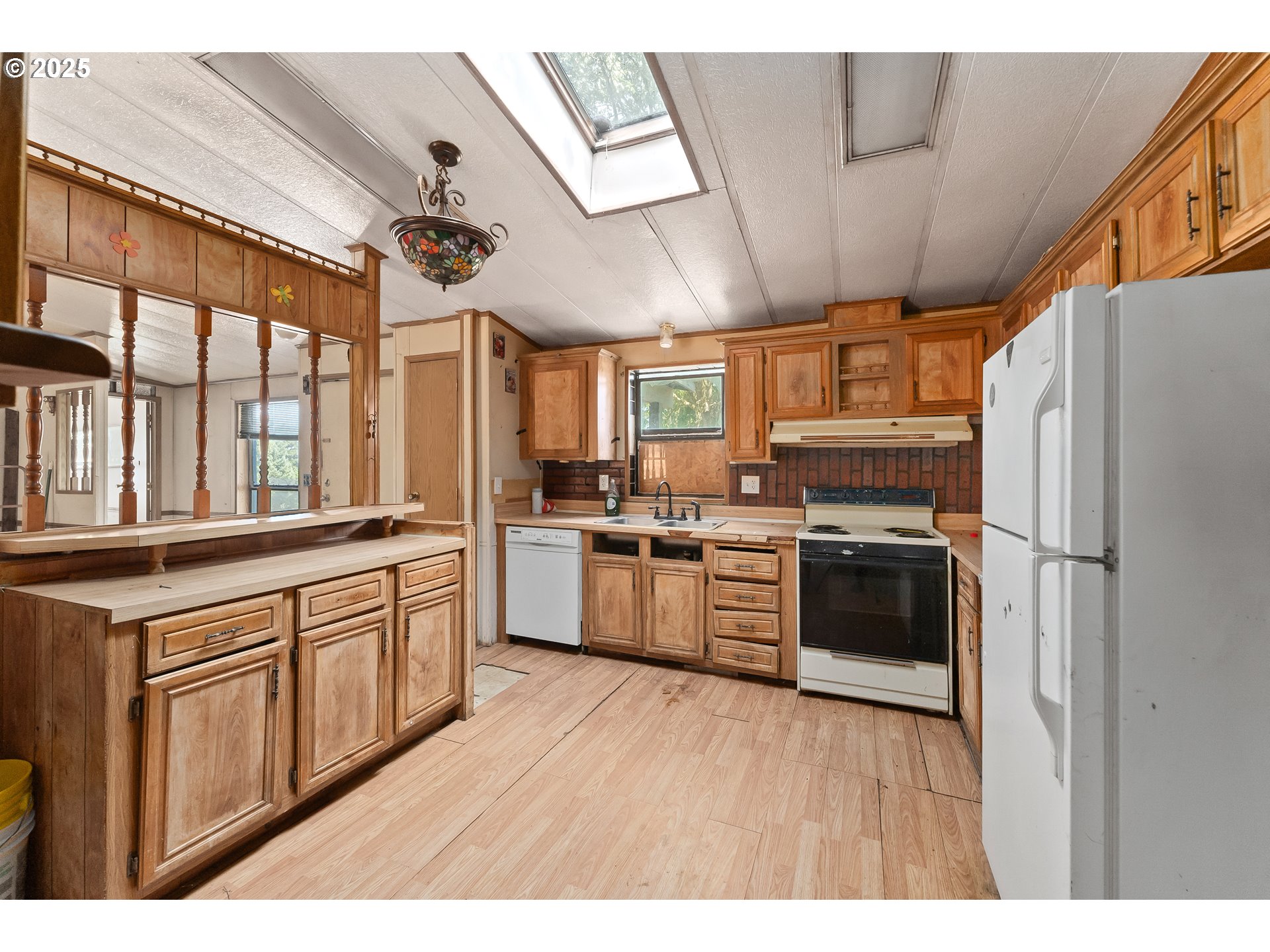 281 Callahan Road Roseburg, OR 97471 - Photo 17 of 39 a kitchen with stainless steel appliances granite countertop a refrigerator a sink dishwasher a stove with wooden cabinets
