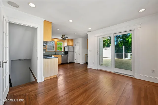 a view of a kitchen with wooden floor and a kitchen