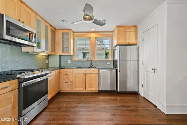 a kitchen with stainless steel appliances granite countertop a refrigerator and a sink