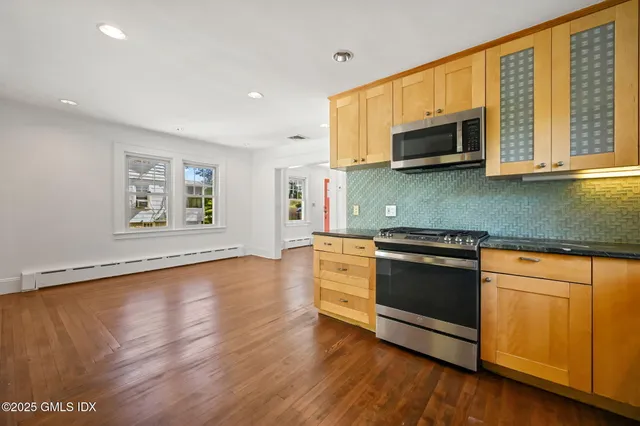 a bathroom with a sink toilet and mirror