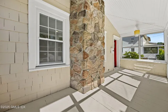 front view of a brick house with a yard