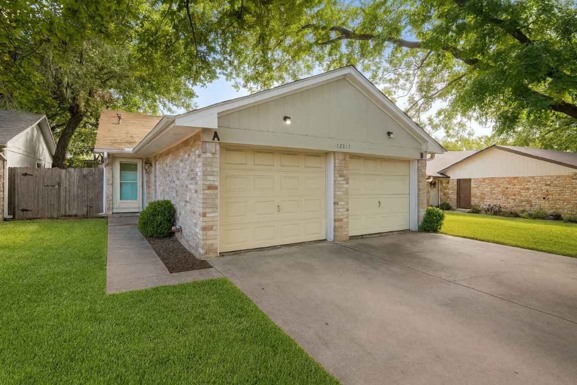 a view of a house with a yard and garage