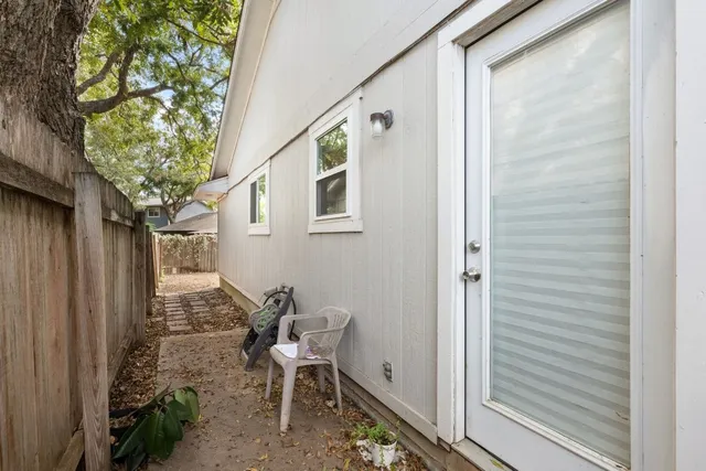a backyard of a house with table and chairs
