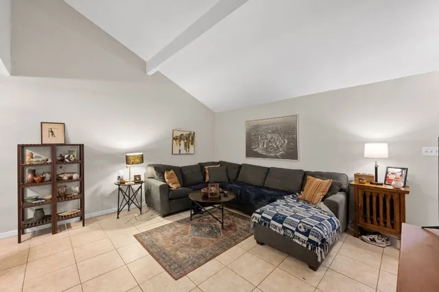 a living room with furniture a table and a window