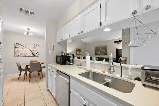 a kitchen with a sink cabinets and window