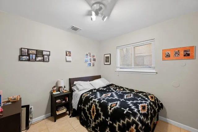 a bedroom with bed and a window