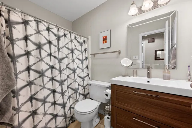 a bathroom with a sink toilet and a mirror