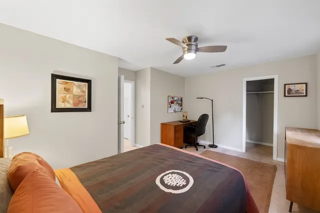 a bedroom with a bed and a table in it