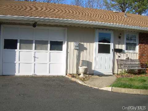 179 Ventry Court, Unit C Ridge, NY 11961 - Photo 1 of 1 a front view of a house with a garage