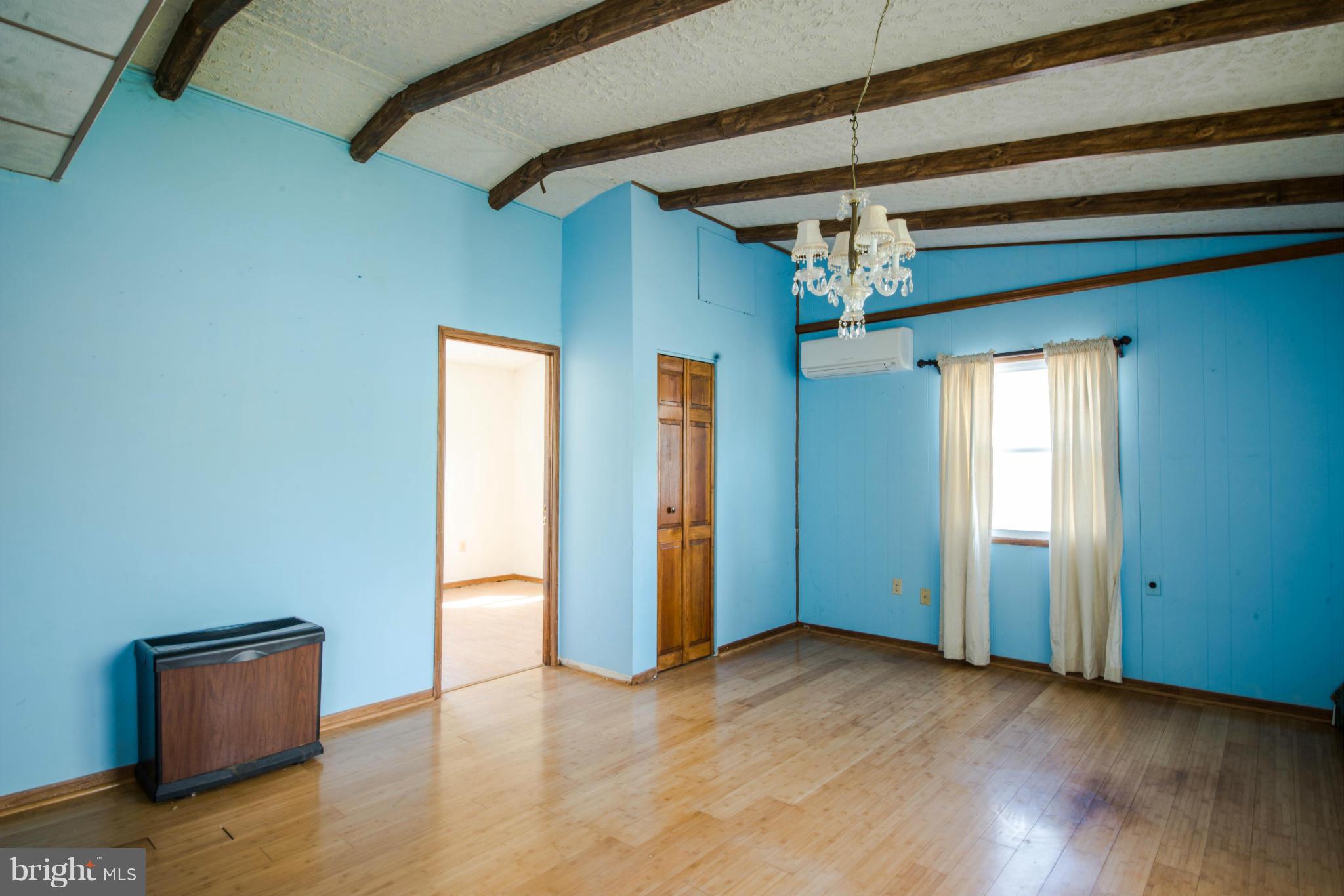 9306 Bethel Road Frederick, MD 21702 - Photo 6 of 19 a view of a livingroom with a ceiling fan window and wooden floor