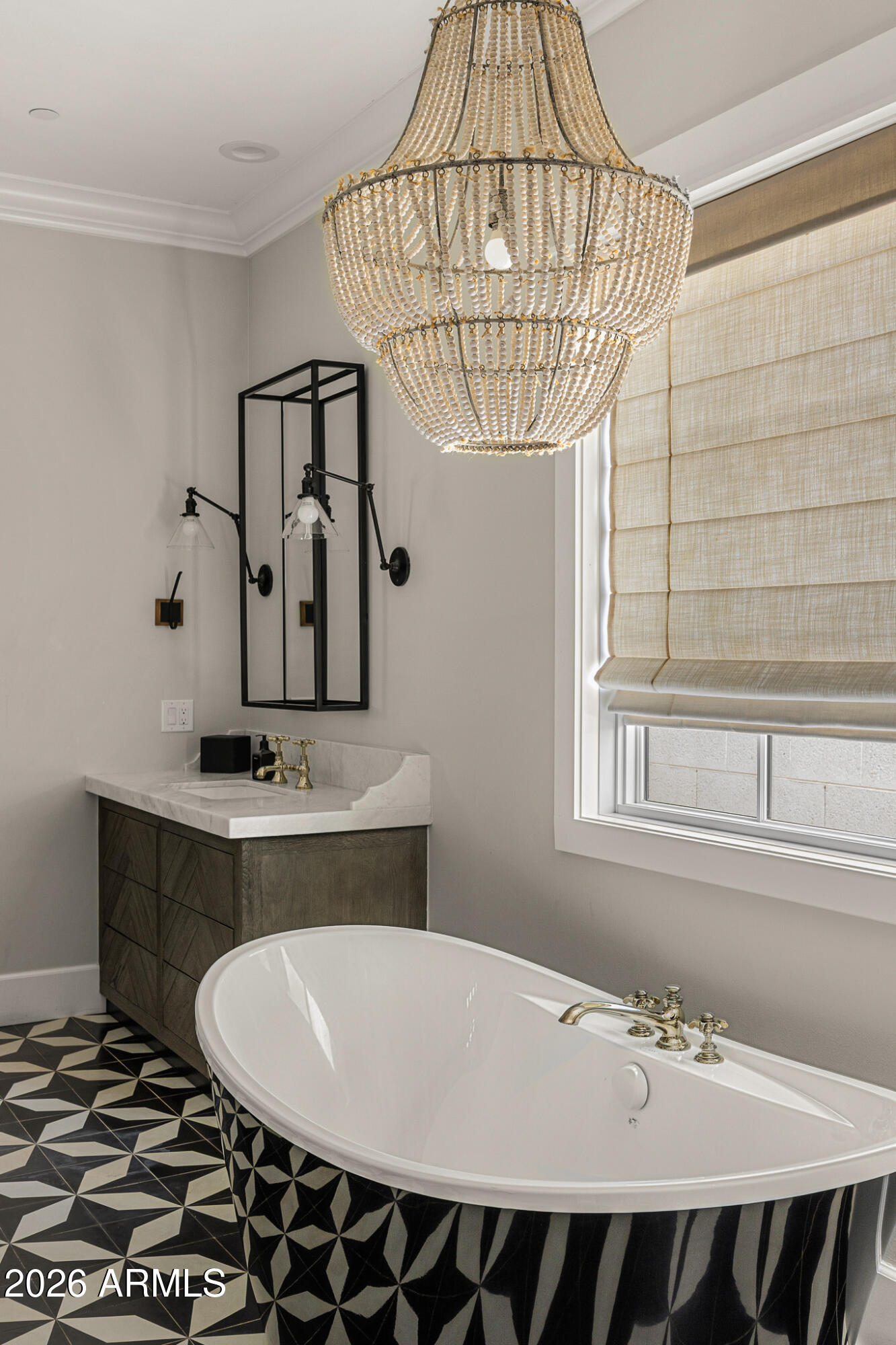 4204 North 57th Way Phoenix, AZ 85018 - Photo 20 of 34 a bathroom with a sink a mirror and a shower