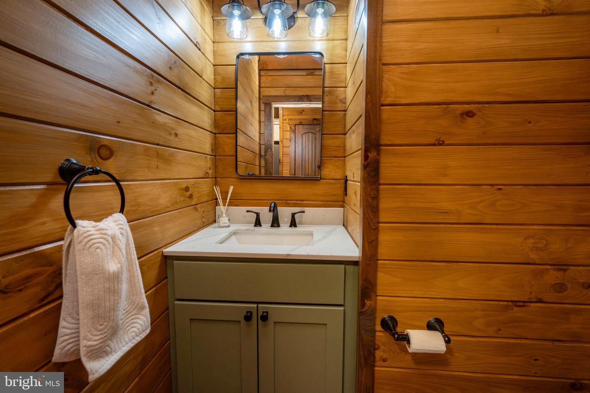 75 Fern Loop Oakland, MD 21550 - Photo 22 of 75 a bathroom with a sink and mirror