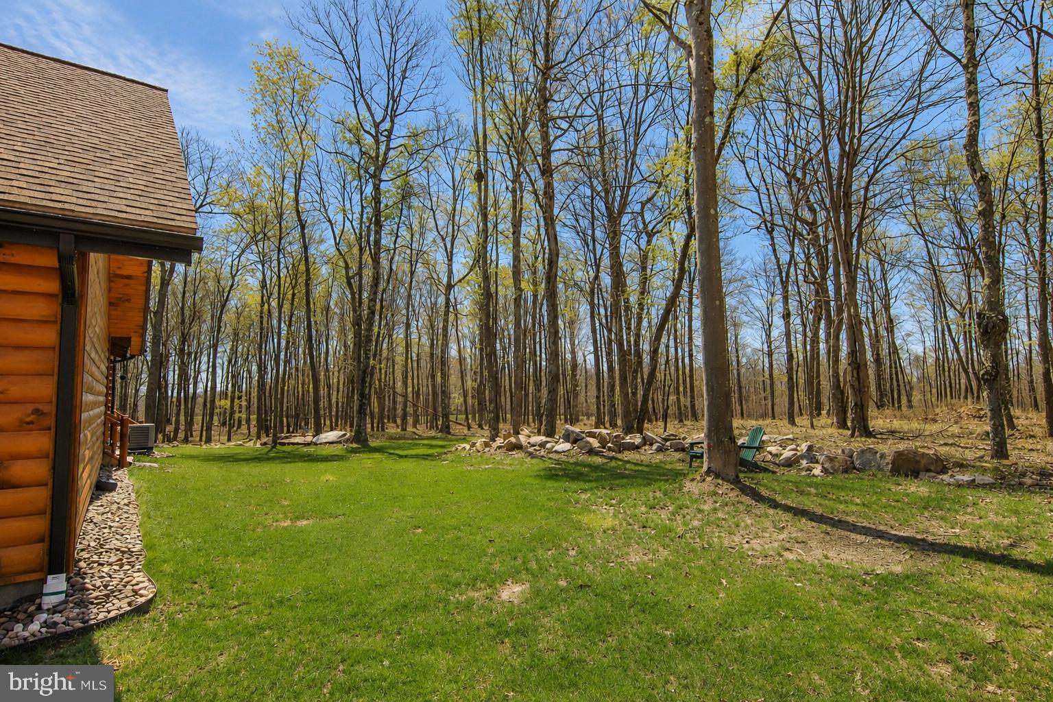 75 Fern Loop Oakland, MD 21550 - Photo 67 of 75 a backyard of a house with lots of green space and fountain