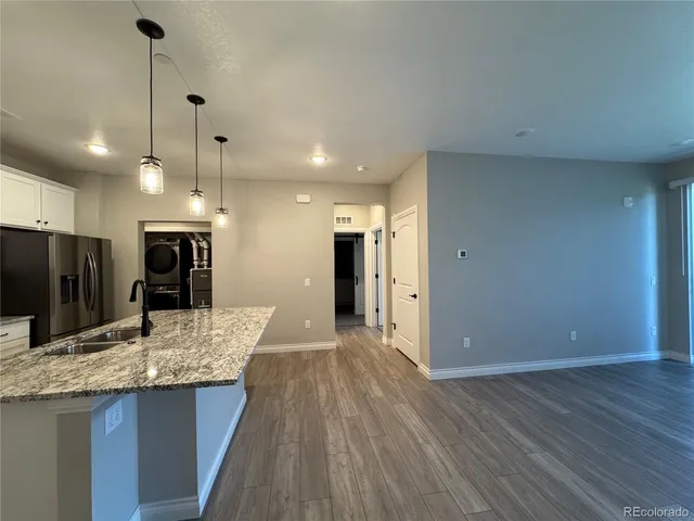 a view of a kitchen with a sink and a refrigerator