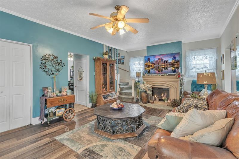 3159 Brodhead Road Aliquippa, PA 15001 - Photo 5 of 30 a living room with furniture a fireplace and a chandelier