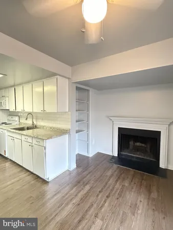a open kitchen with a sink and a fireplace