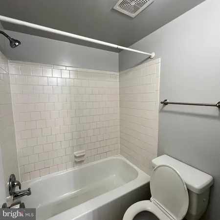 a bathroom with a toilet and a bathtub