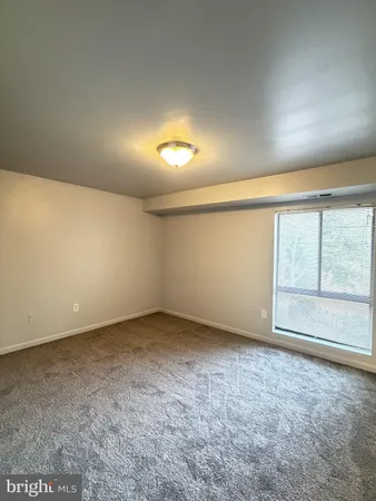 an empty room with a empty space and windows