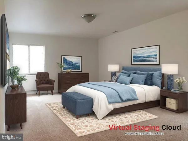 a spacious bedroom with a bed a couch and a large window