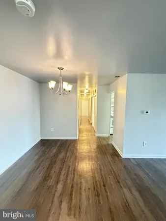 a view of a room with wooden floor