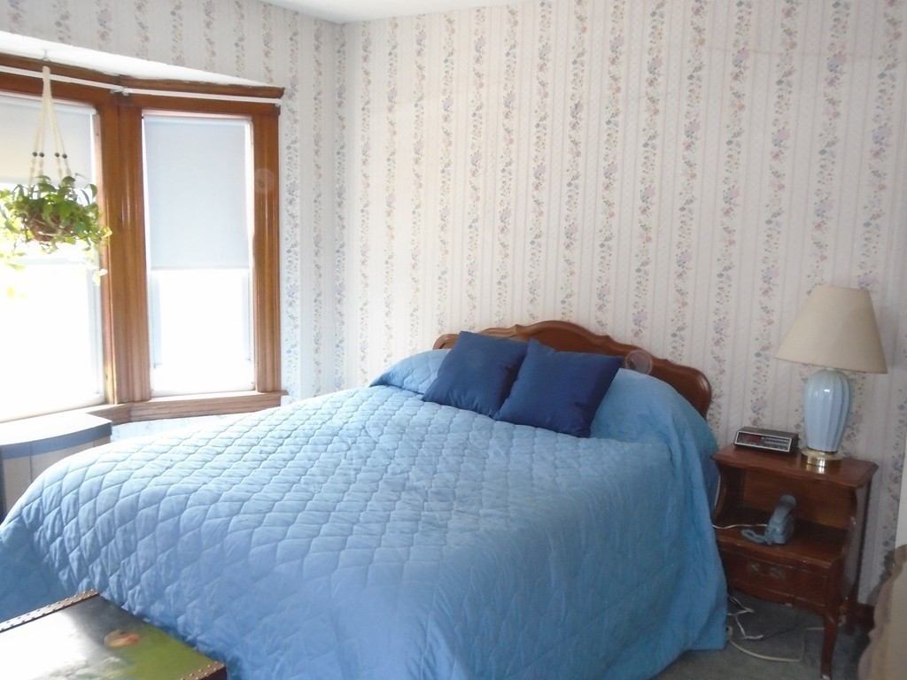 33 Chesterfield Road Worcester, MA 01602 - Photo 17 of 29 a bedroom with a bed and a chair