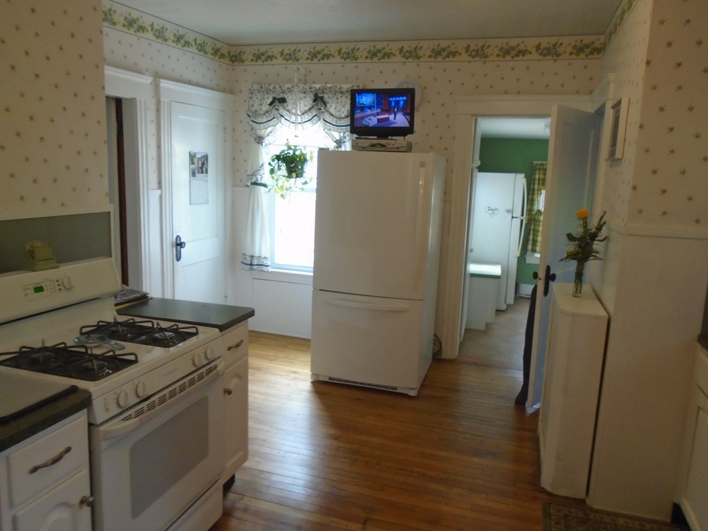 33 Chesterfield Road Worcester, MA 01602 - Photo 6 of 29 a kitchen with a refrigerator a stove and wooden floor