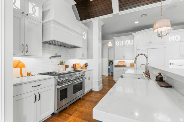 2917 Old Farm Road Washington, UT 84780 - Photo 18 of 105 Kitchen featuring light stone counters, double oven range, dark wood finished floors, and white cabinetry