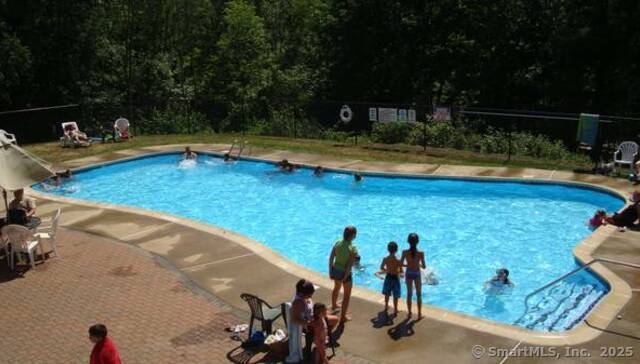8 S Road, Unit W86 Stafford, CT 06076 - Photo 18 of 20 a view of a swimming pool with an outdoor seating