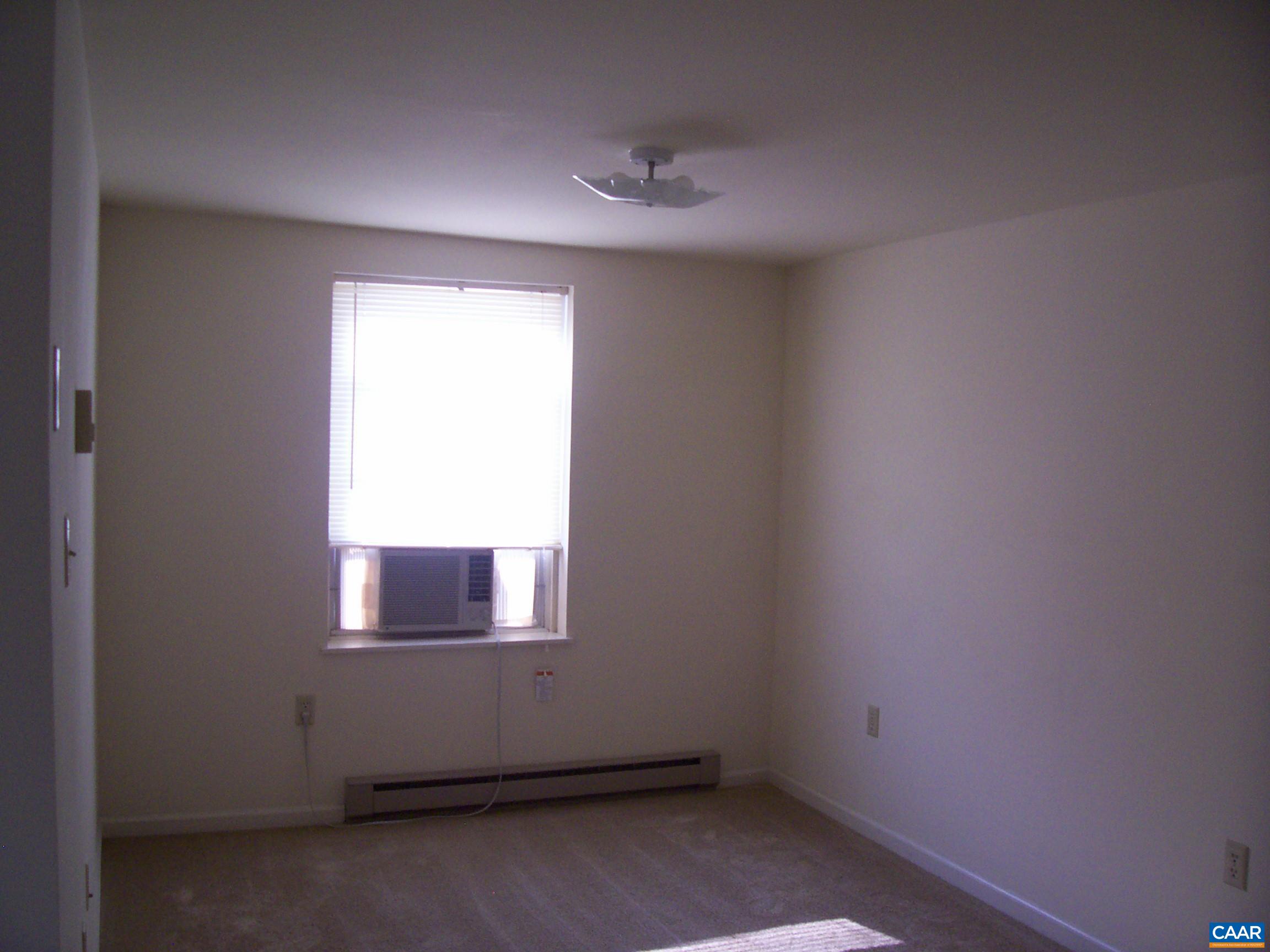 211 Chancellor Street, Unit A Charlottesville, VA 22903 - Photo 3 of 8 an empty room with a window