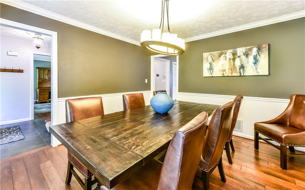 3844 Grove Road Gibsonia, PA 15044 - Photo 12 of 25 Formal dinning room with chair rail, striking chandelier and those beautiful hardwoods.