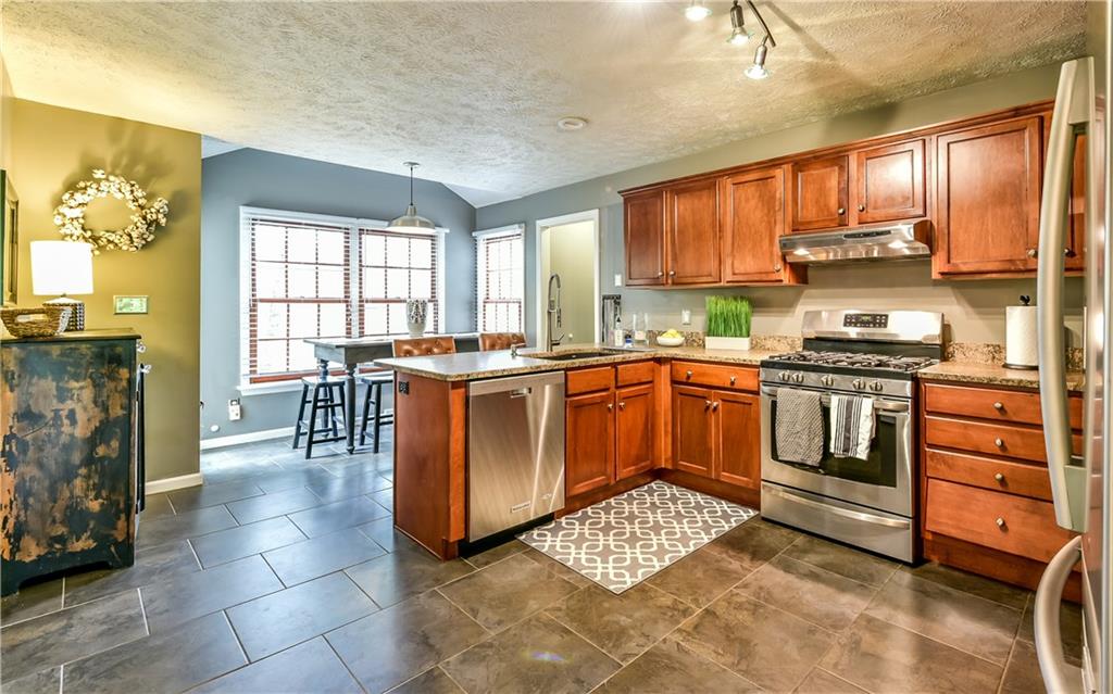 3844 Grove Road Gibsonia, PA 15044 - Photo 14 of 25 Spacious kitchen with large ceramic tile flooring, stainless steel appliances and granite countertops.