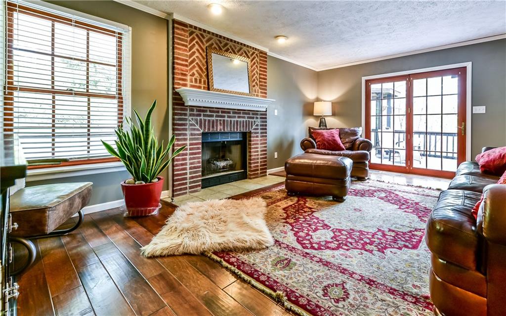 3844 Grove Road Gibsonia, PA 15044 - Photo 8 of 25 Large family room with gas fireplace at the end of the hallway. Check out those gorgeous hardwood floors from Paracca Flooring!