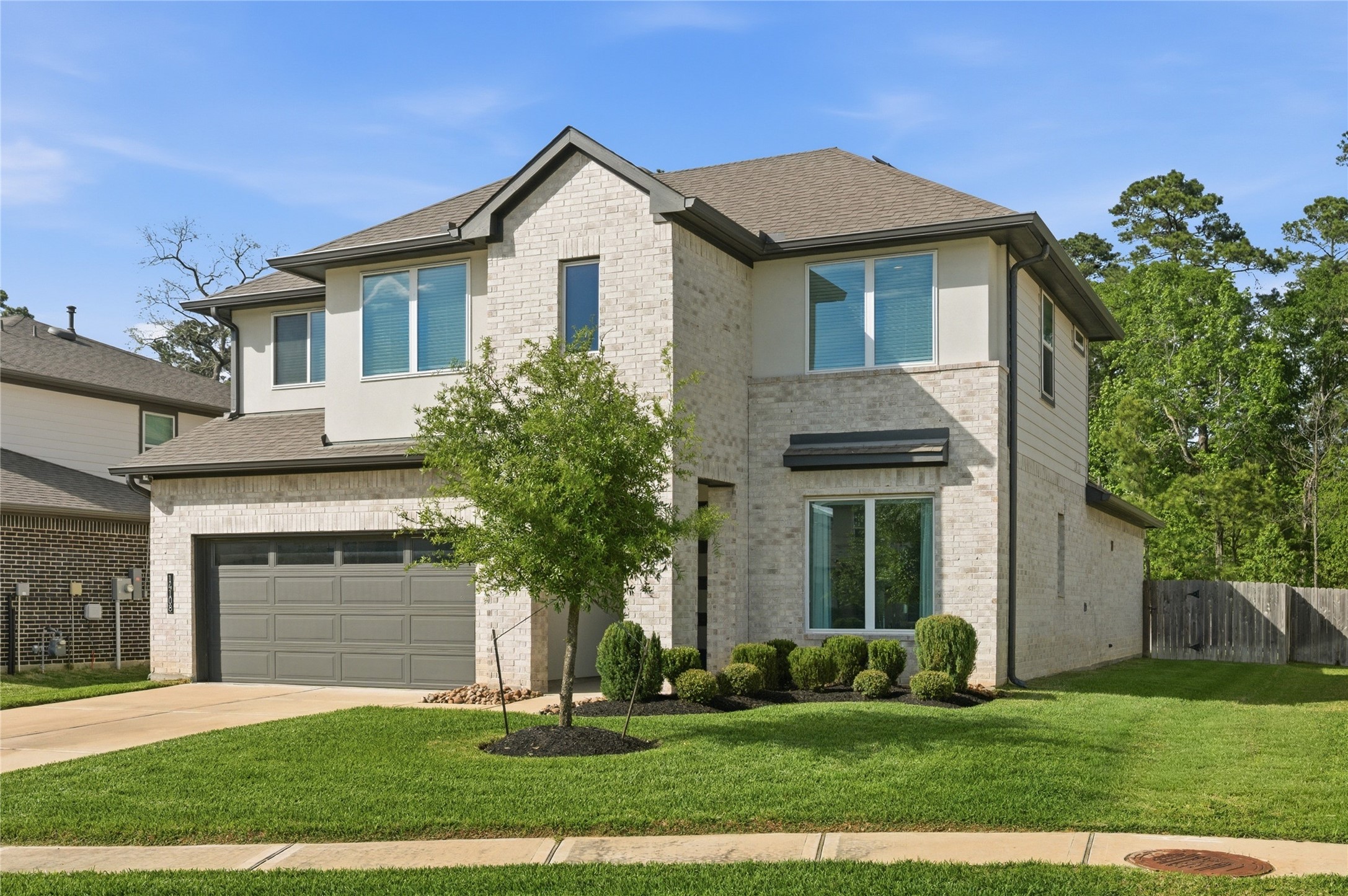 14108 Redfish Lake Conroe, TX 77384 - Photo 2 of 37 a front view of a house with a yard and potted plants