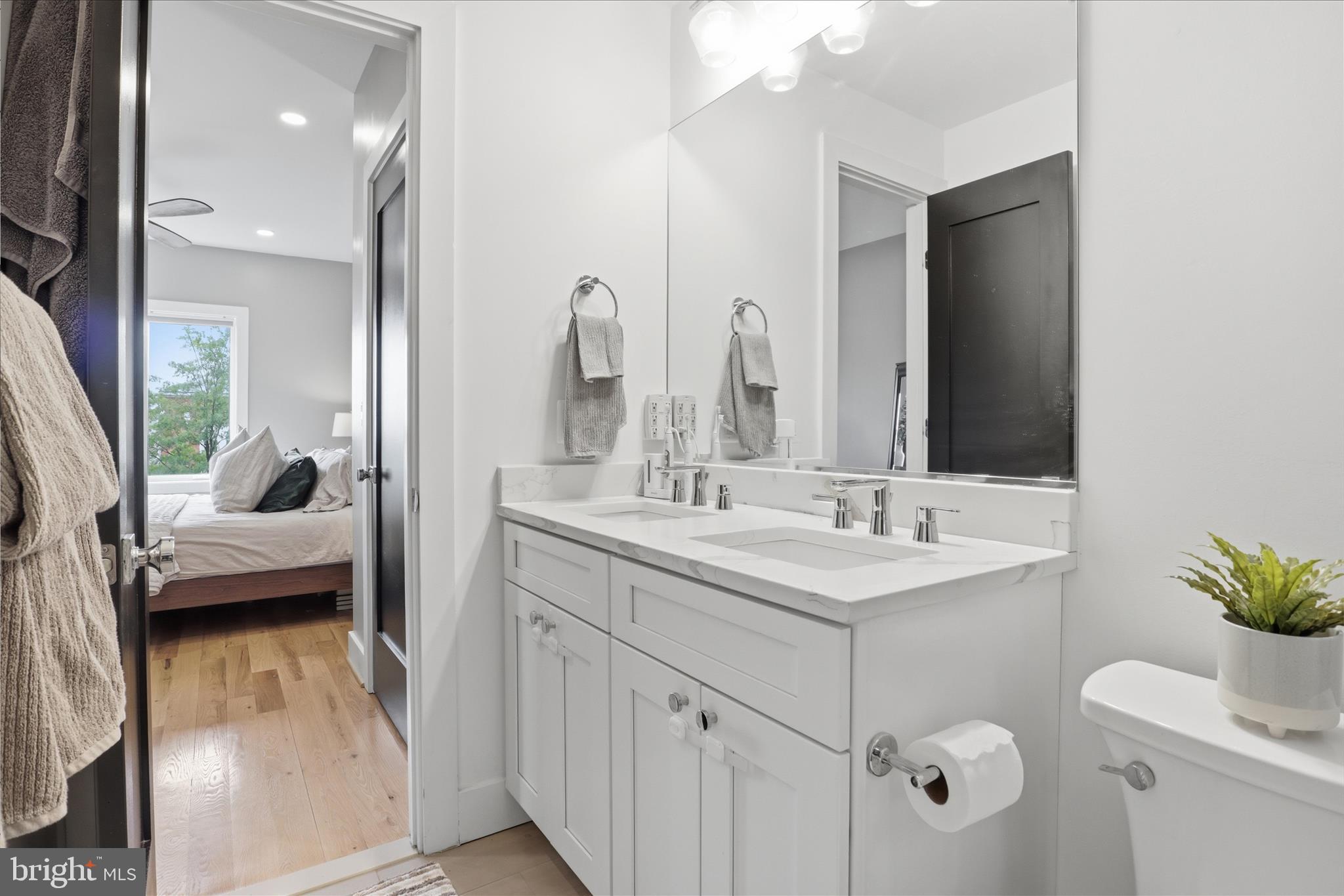 1222 Neal Street Northeast, Unit 3 Washington, DC 20002 - Photo 28 of 38 a en suite bathroom with a double vanity sink and mirror