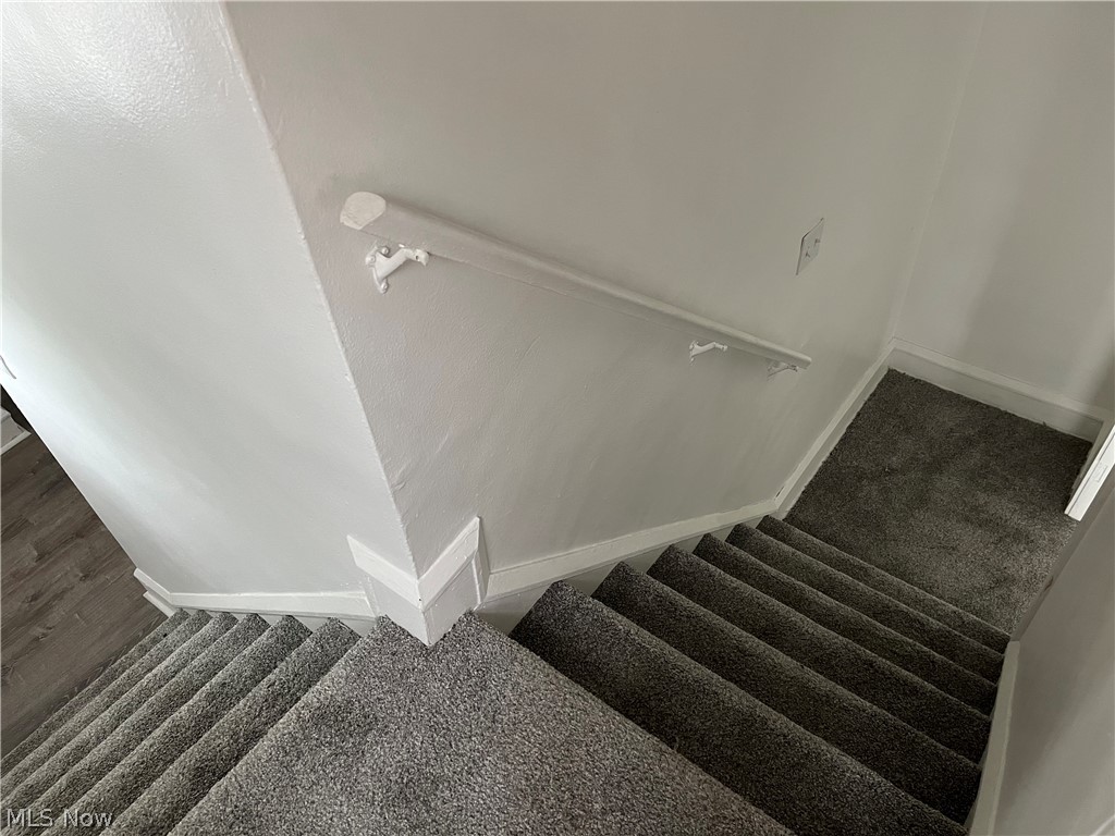 3550 Pennington Road Cleveland, OH 44120 - Photo 10 of 16 Staircase with dark colored carpet - steps from kitchen and living room