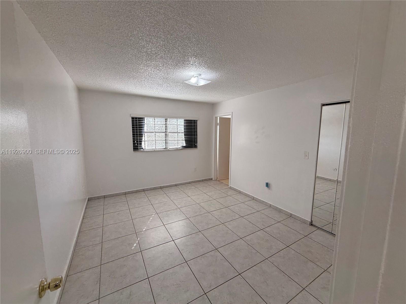15969 Northwest 64th Avenue, Unit 504 Miami Lakes, FL 33014 - Photo 11 of 21 a view of an empty room and window