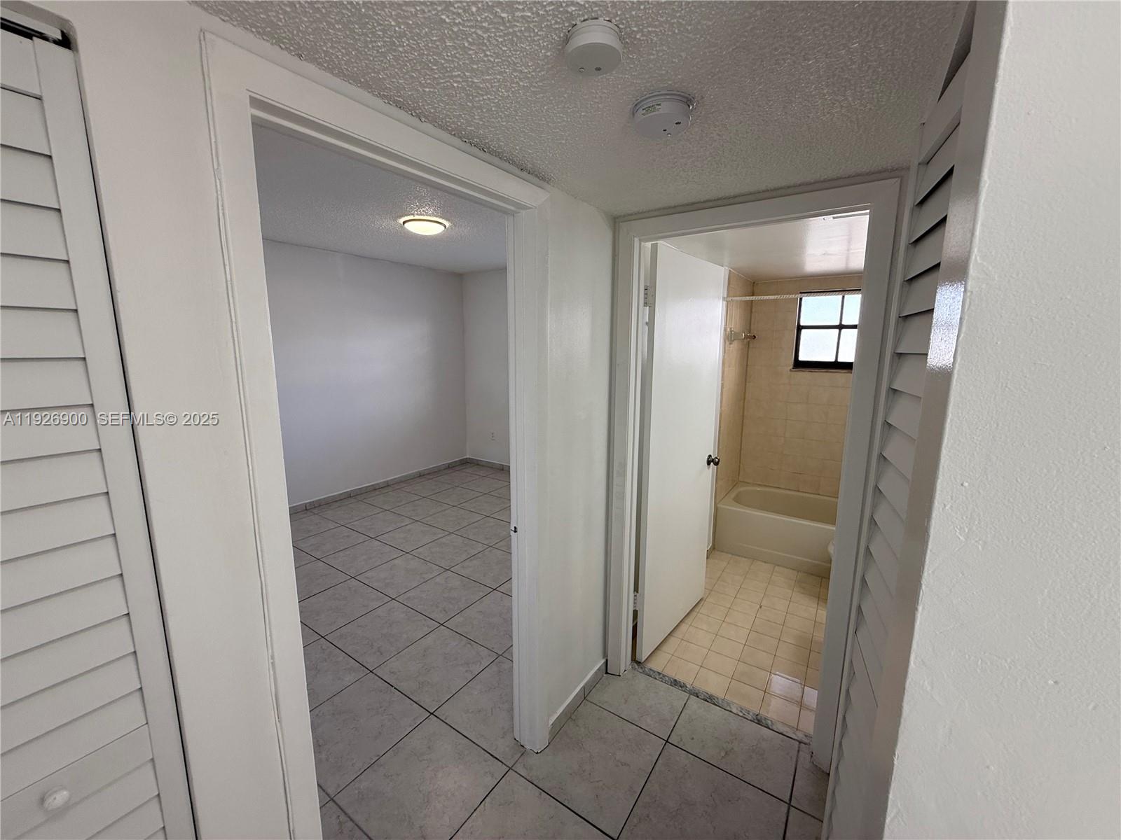 15969 Northwest 64th Avenue, Unit 504 Miami Lakes, FL 33014 - Photo 15 of 21 a view of a hallway with wooden shelves