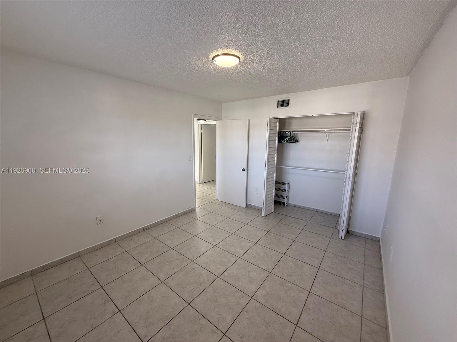 15969 Northwest 64th Avenue, Unit 504 Miami Lakes, FL 33014 - Photo 16 of 21 a view of an empty room and closet area