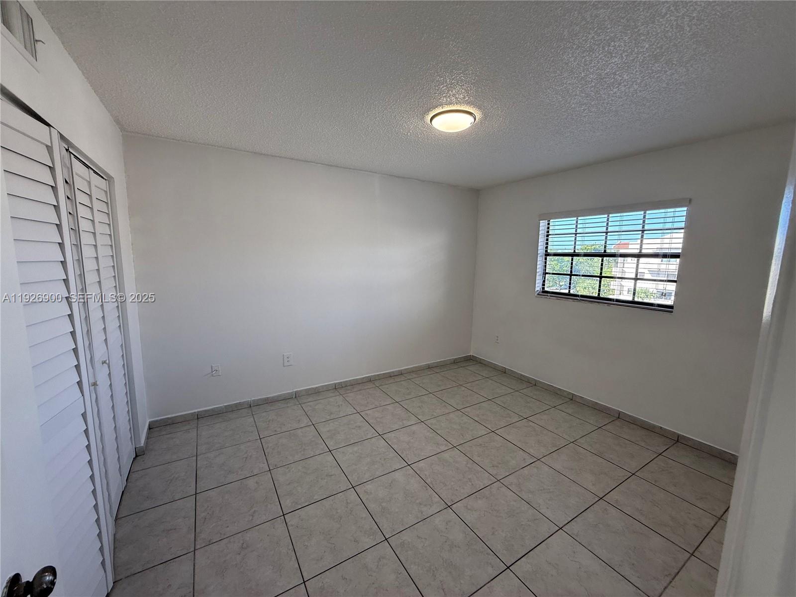 15969 Northwest 64th Avenue, Unit 504 Miami Lakes, FL 33014 - Photo 17 of 21 an empty room with windows