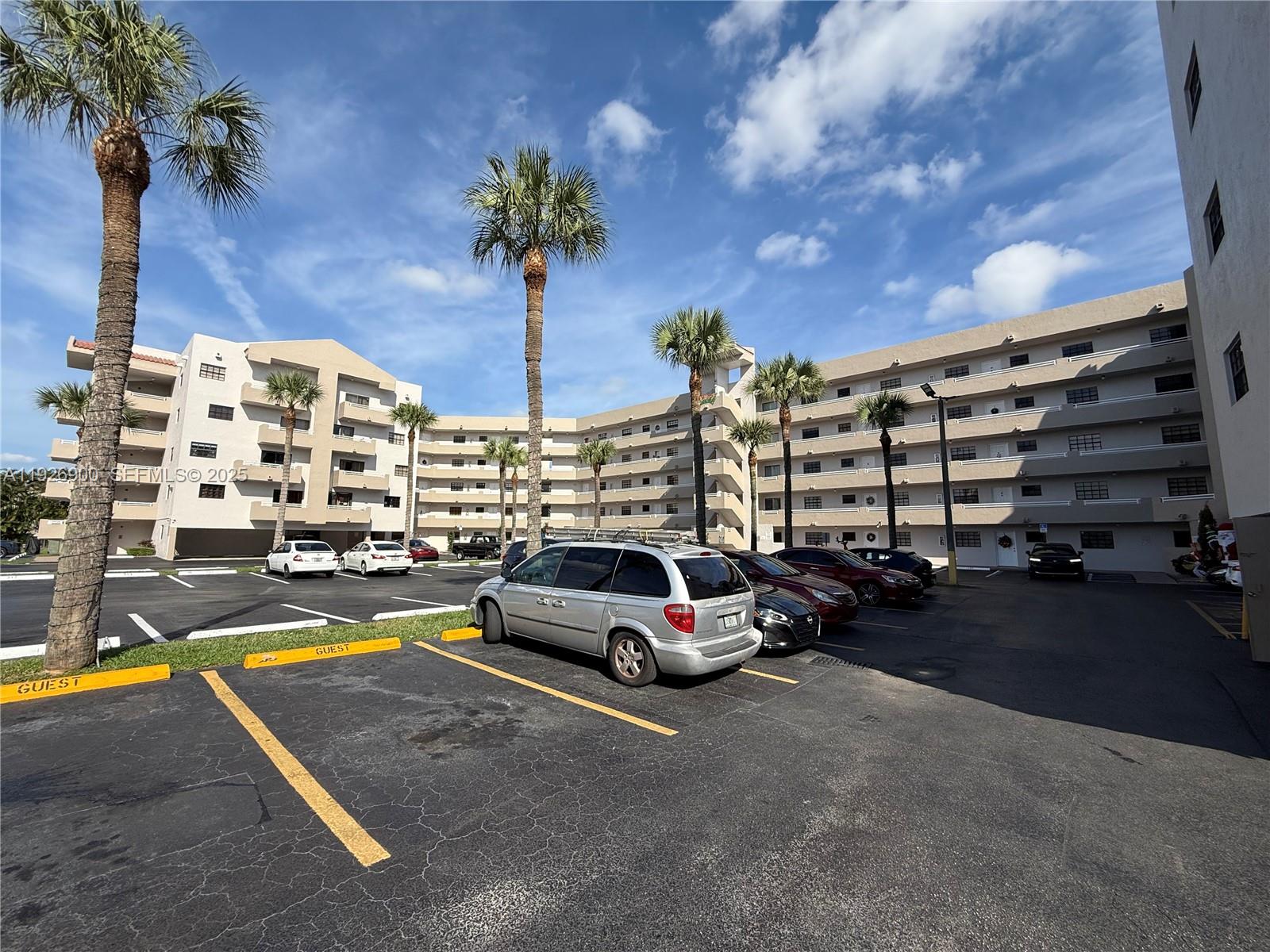 15969 Northwest 64th Avenue, Unit 504 Miami Lakes, FL 33014 - Photo 3 of 21 a swimming pool with outdoor seating and yard