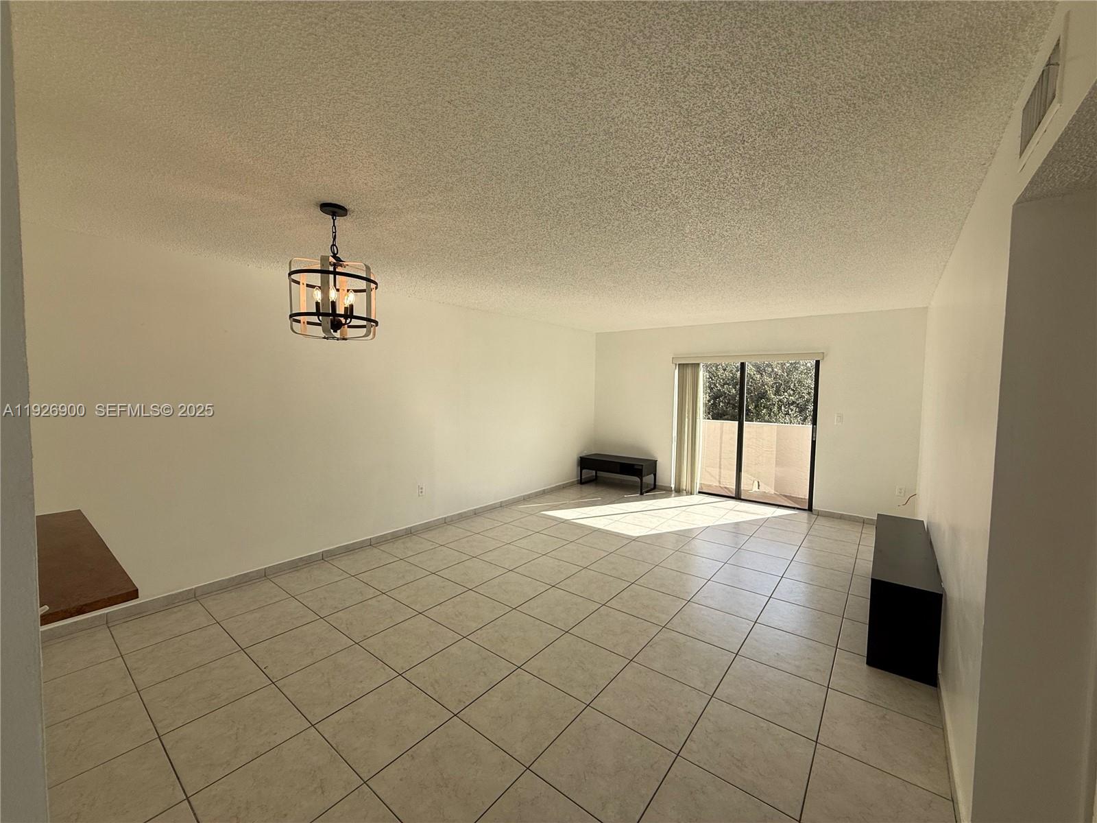 15969 Northwest 64th Avenue, Unit 504 Miami Lakes, FL 33014 - Photo 9 of 21 an empty room with a empty space and a window