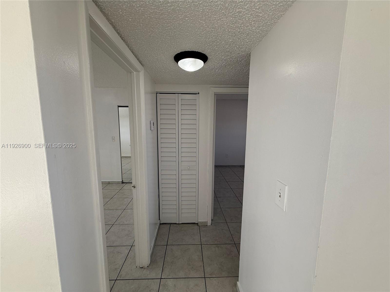 15969 Northwest 64th Avenue, Unit 504 Miami Lakes, FL 33014 - Photo 10 of 21 view of a livingroom with closet